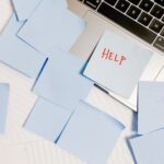 a laptop with sticky notes on it